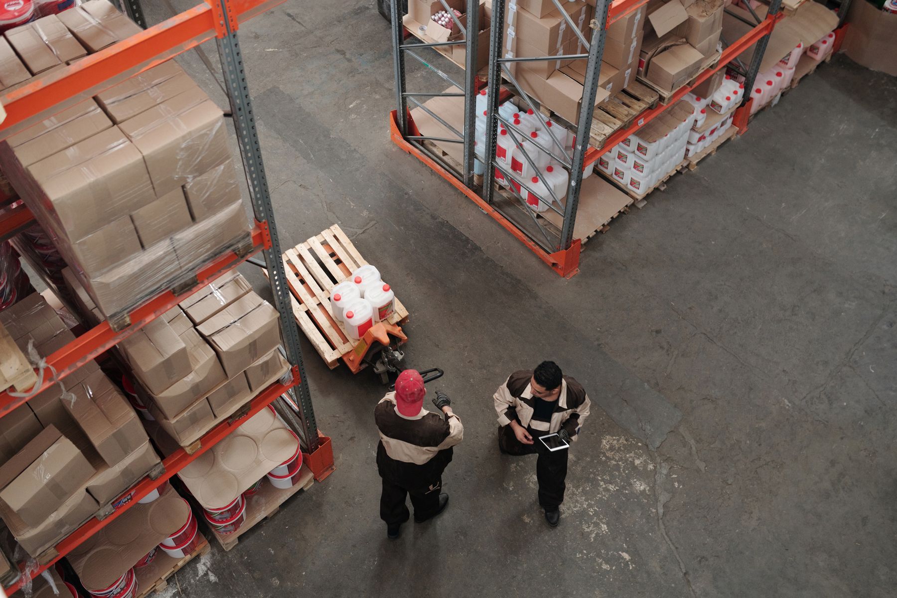 Professionals reviewing trade operations in a warehouse